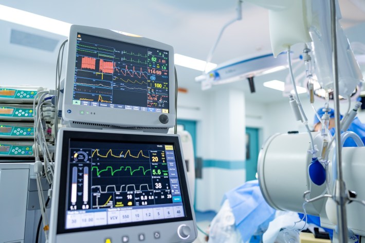 OR surgical monitoring gear. Advanced medical equipment displays vital signs and patients' data in a modern hospital operating room environment.
