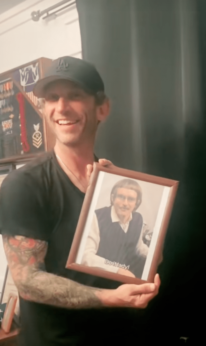 holding framed portrait of Chit