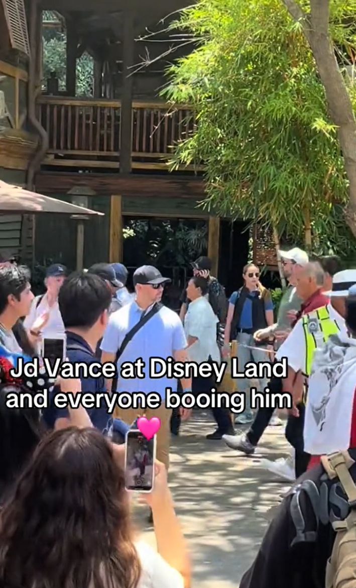 JD Vance surrounded by secret service in plainclothes getting booed at Disneyland.
