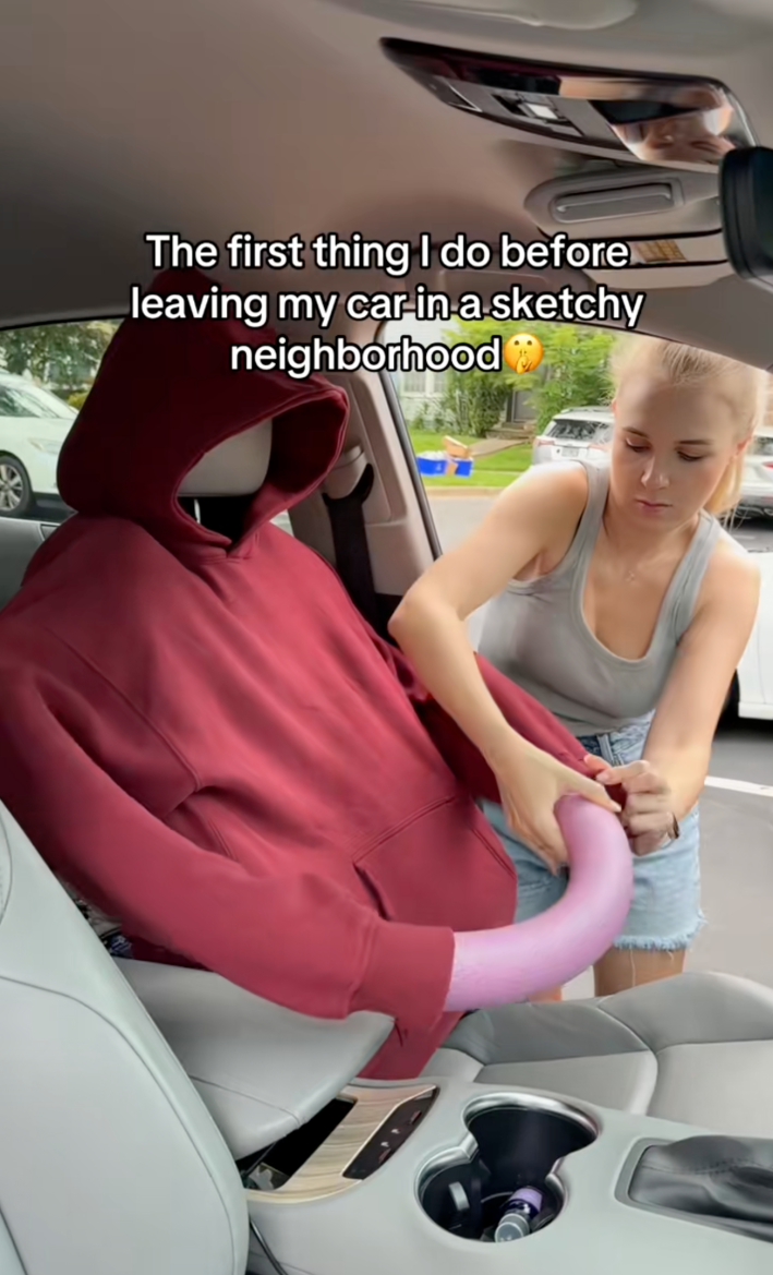 homemade mannequin in car driver seat captioned "The first thing I do before leaving my car in a sketchy neighborhood."