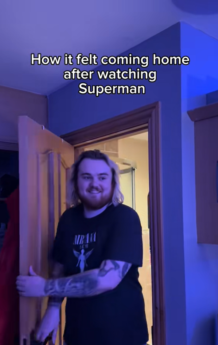 TikTok video of a person smiling as they enter a room. Text reads, "How it felt coming home after watching Superman."