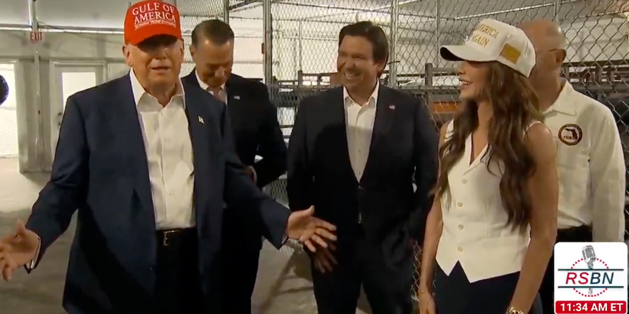 President Donald Trump touring new detainment facility "Alligator Alcatraz" and laughing alongside Florida Governor Ron DeSantis and Homeland Security Secretary Kristi Noem.