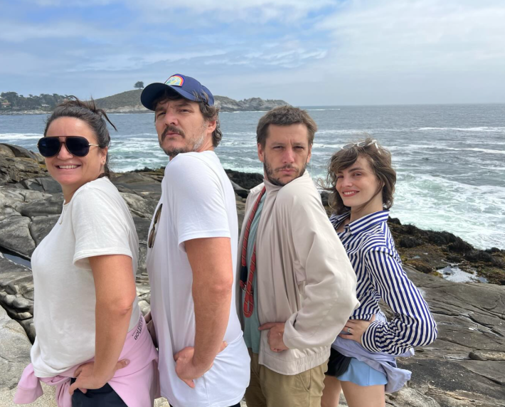 Pascal and his family lined up and doing the super hero pose for the camera at the beach.