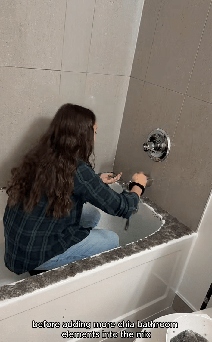 Woman in her bathtub spreading chia seeds over her tub.