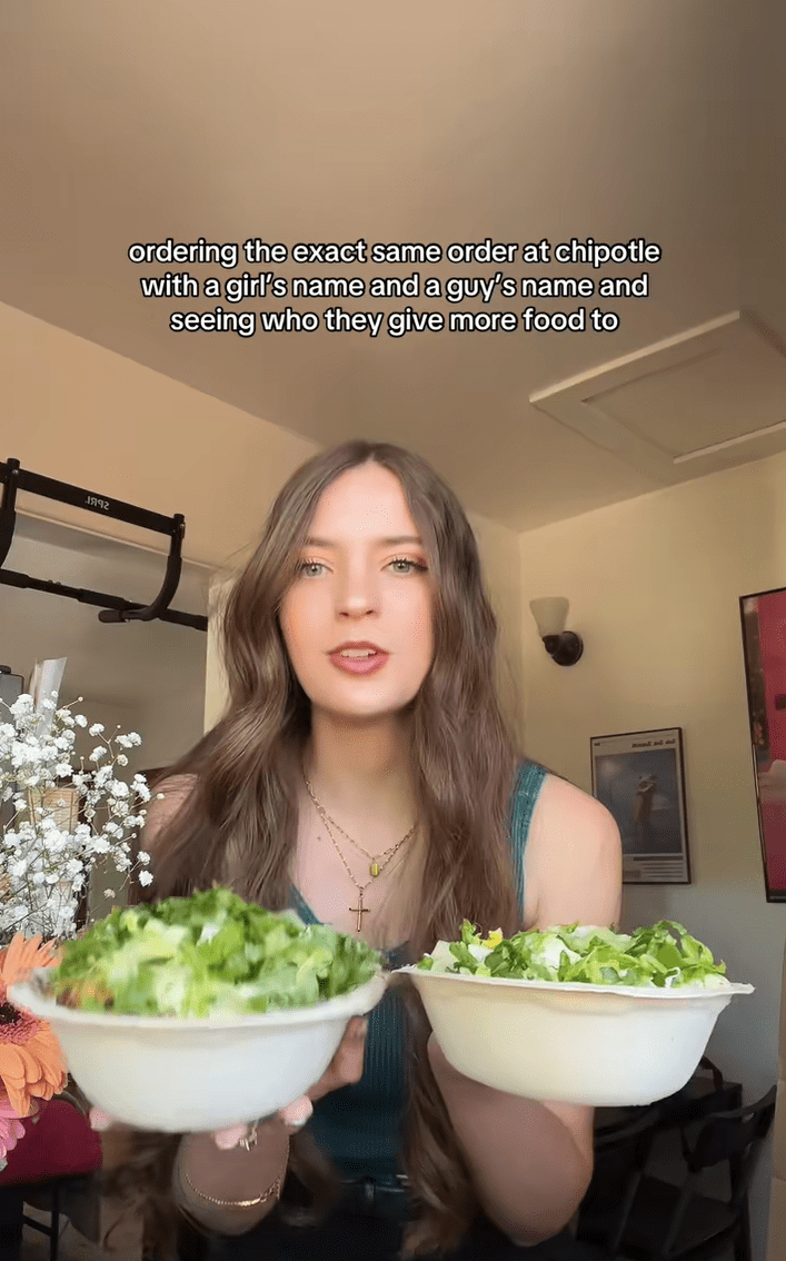 A woman holding up two takeout bowls filled with salads. Text reads, "ordering the exact same order at chipotle with a girl's name and a guy's name and seeing who they give more food to."