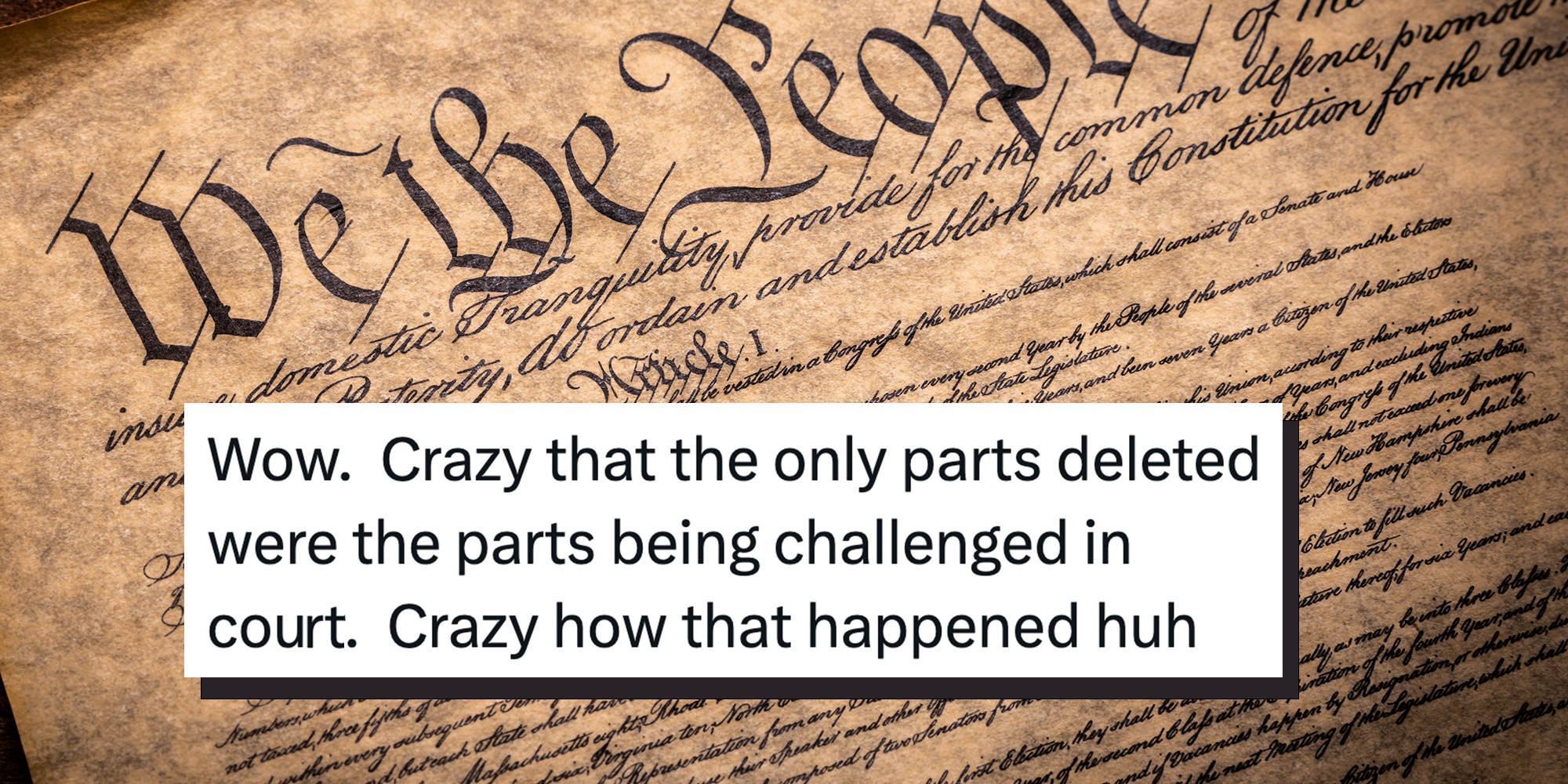 A copy of the Constitution of the United Sates of American on a wooden background. Tweet overlay reads "Wow. Crazy that the only parts deleted were the parts being challenged in court. Crazy how that happened huh."