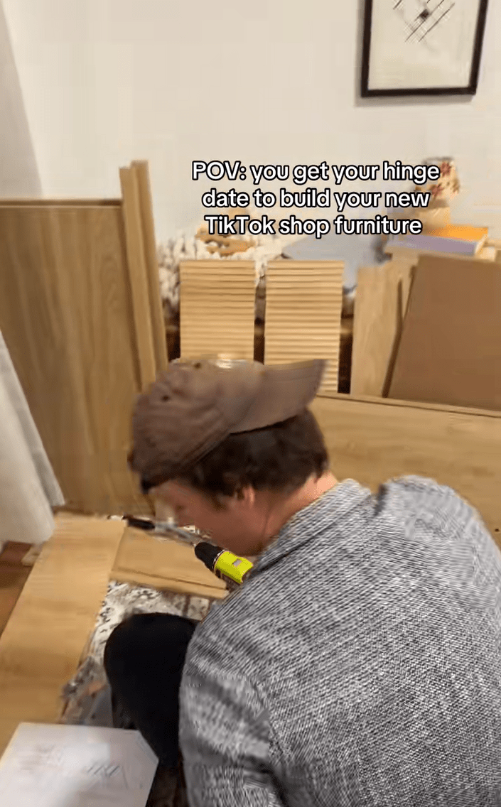 Video of a man building furniture. Text overlay reads, "POV: You get your Hinge date to build your new TikTok shop furniture."