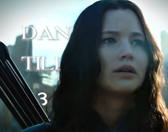Katniss Everdeen from The Hunger Games, "dance til 3" text behind her.