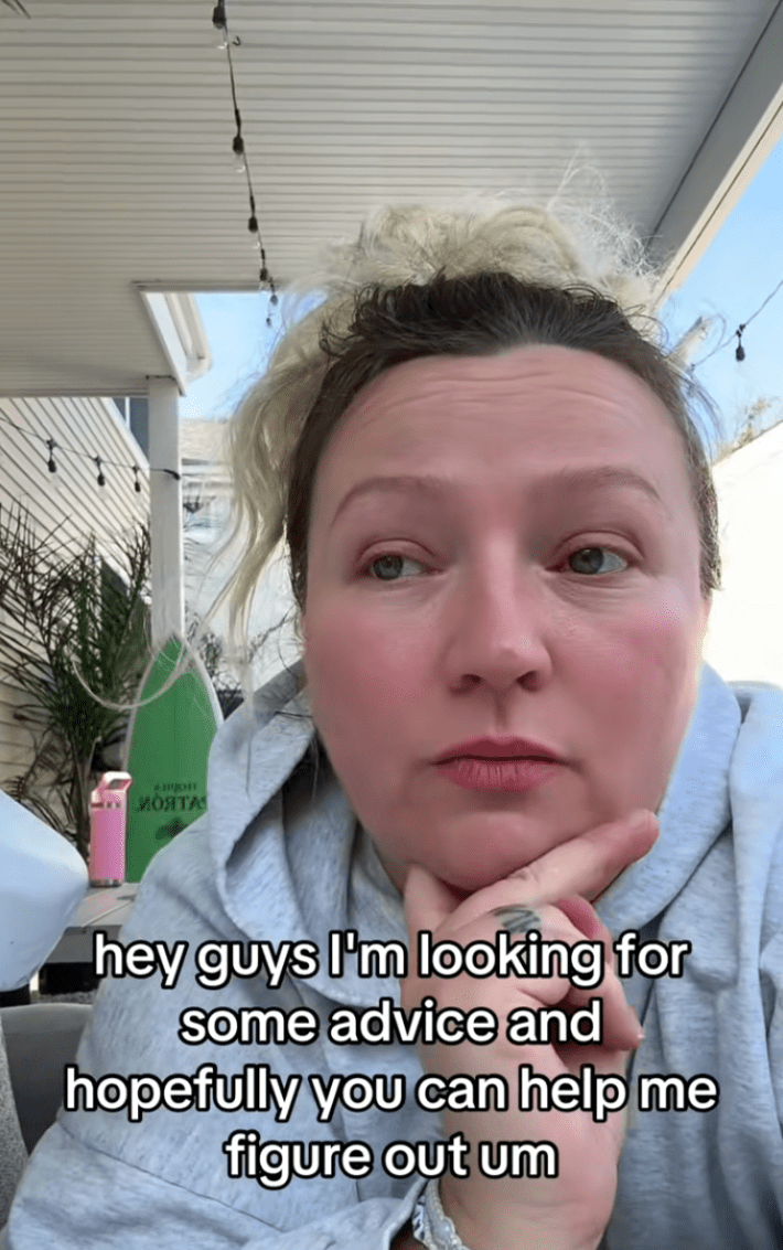 Woman with her head in her hand, saying, "Hey guys I'm looking for some advice and hopefully you can help me figure out"