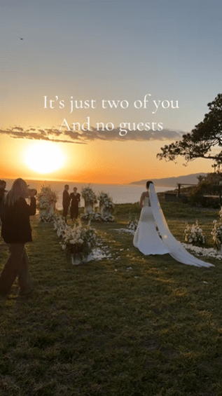 Sunset wedding with the ocean in the background, just the officiant, bride and groom, and photographers present.