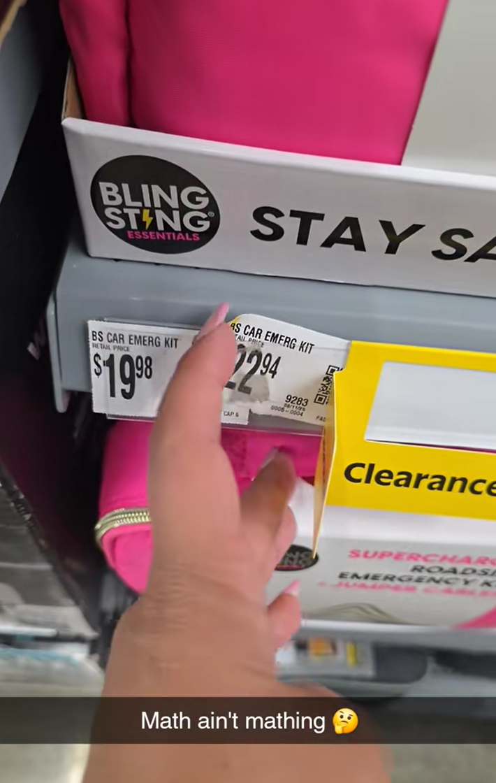 A woman with long nails revealing that the clearance price of $22.94 is on a $19.98 item.