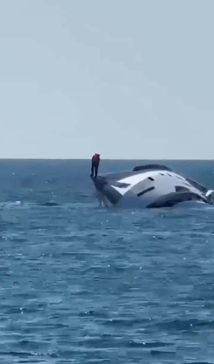 $1 million yacht capsizing, presumably the owner standing on the side of the yacht.