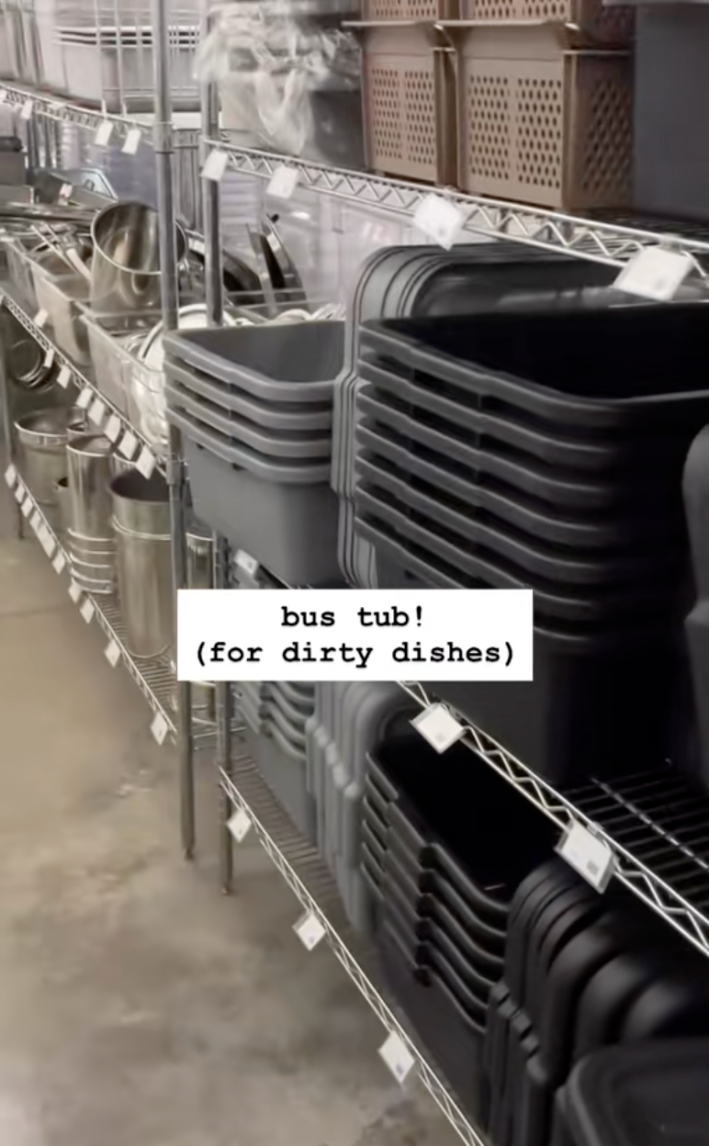 Stacks of bus bins in a restaurant supply store.