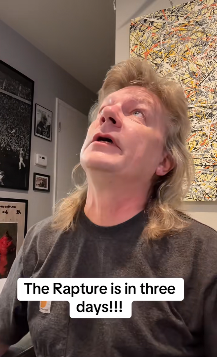 A man looking up at the ceiling as he explains a video a woman posted about looking up when you're Raptured.