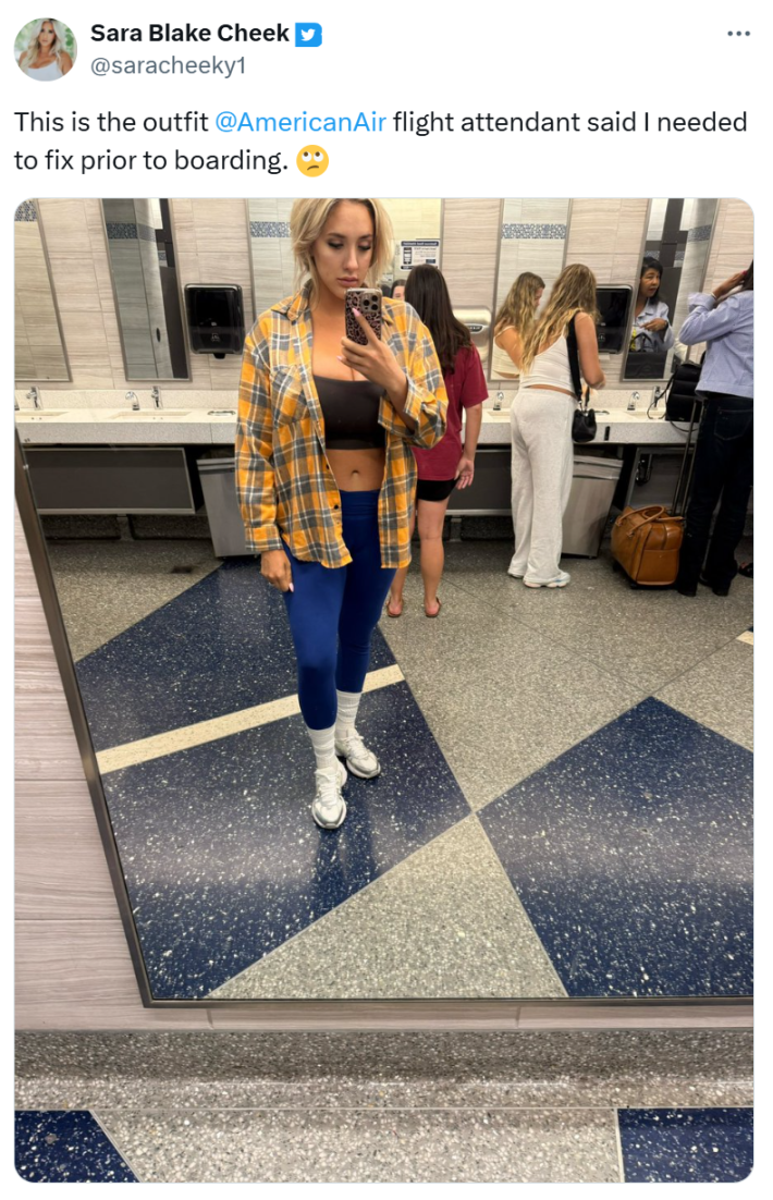 A full-body shot of Cheek's outfit from an airport bathroom.