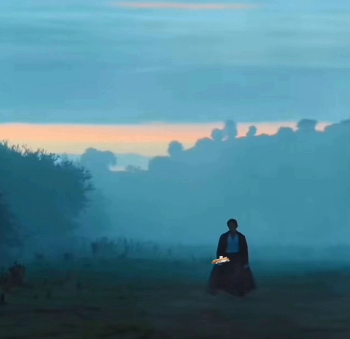 Darcy holding a hotdog in a still from the movie Pride and Prejudice.