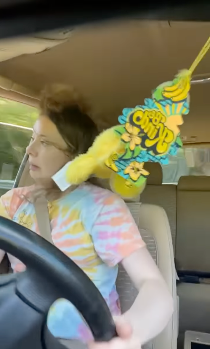 Woman grimacing while trying to correct her car as she skids.