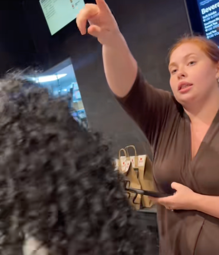 @styledbymoonkk wrote in onscreen text, “McDonalds so understaffed the customers in here passing out the orders  😭." Customer passing out orders in crowded McDonalds