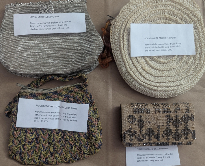 collection of vintage purses with descriptive notes from each