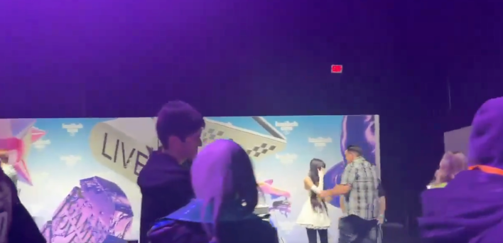 man walking up to a woman at a meet and greet