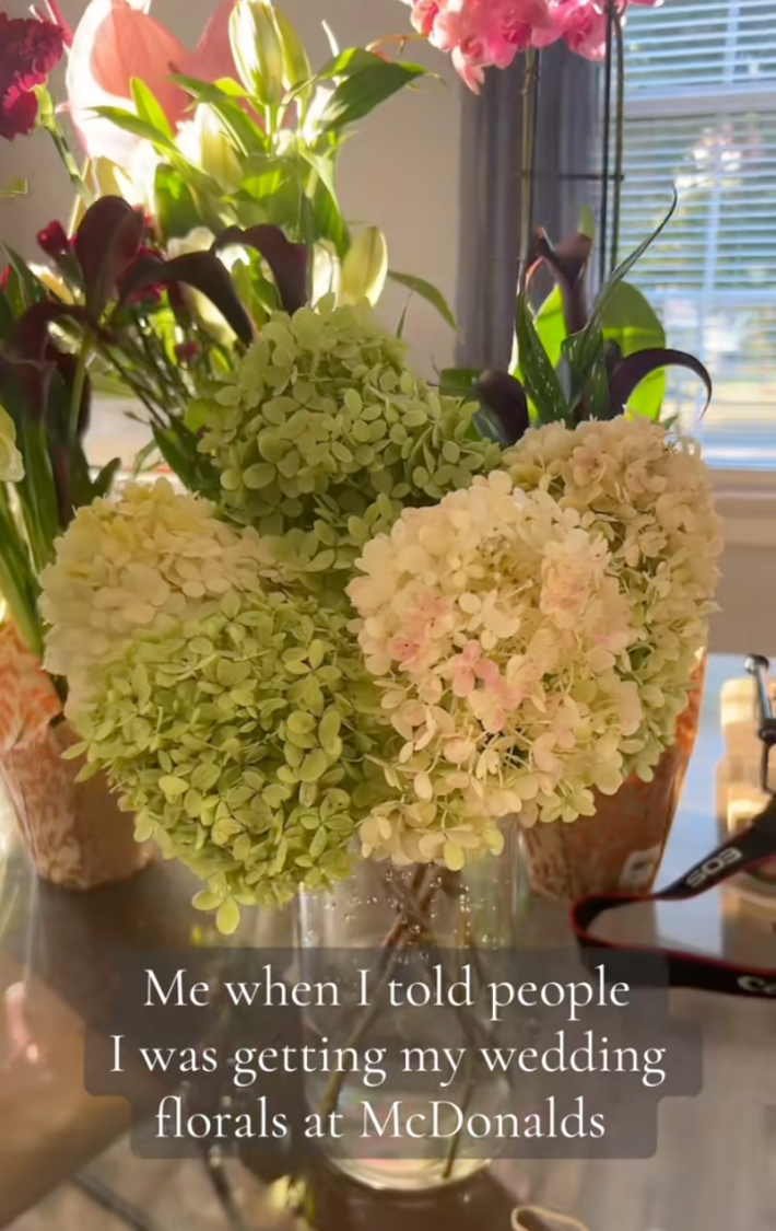 Bunches of flowers sitting in vases inside a house.