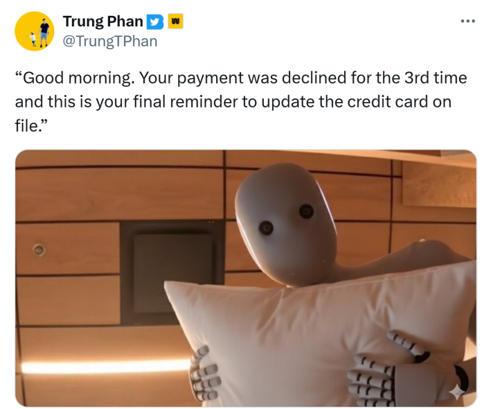 Tweet that reads, "Good morning. Your payment was declined for the 3rd time and this is your final reminder to update the credit card on file." with a photo of the NEO robot holding a pillow staring down at the camera.