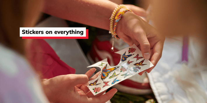woman holding a sheet of stickers