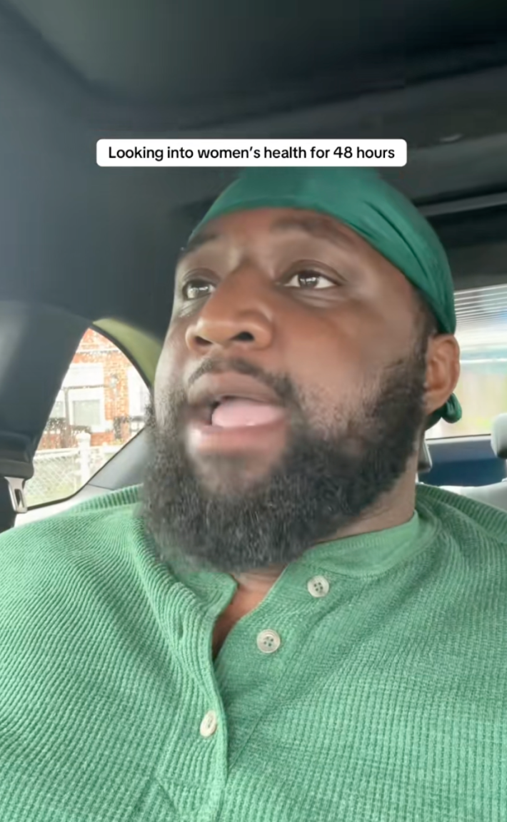 A Black man sitting in his car talking to the camera. Text overlay reads, "Looking into women's healthcare for 48 hours."