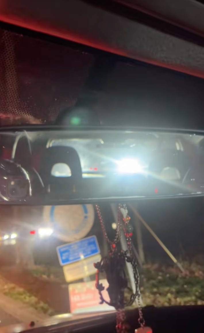 @alexamcnee/TikTok glare from bright headlights in traffic in rearview mirror