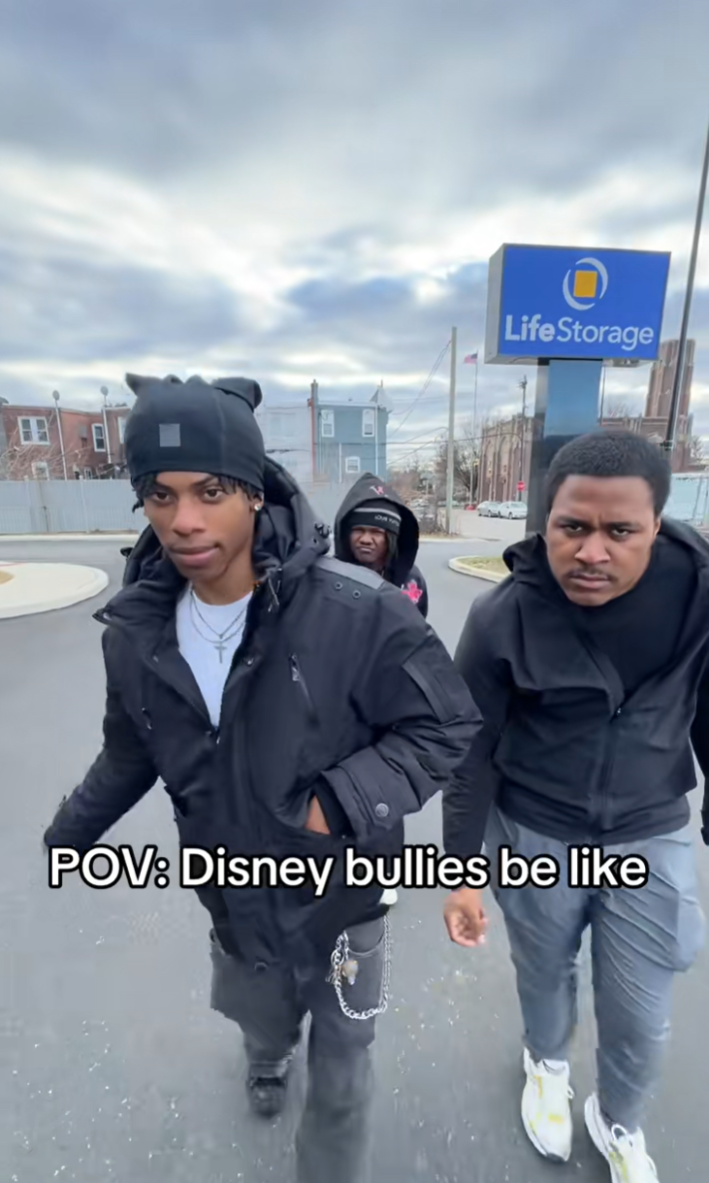 Three people acting like Disney bullies walking up to someone outside like the Sharks from West Side Story.