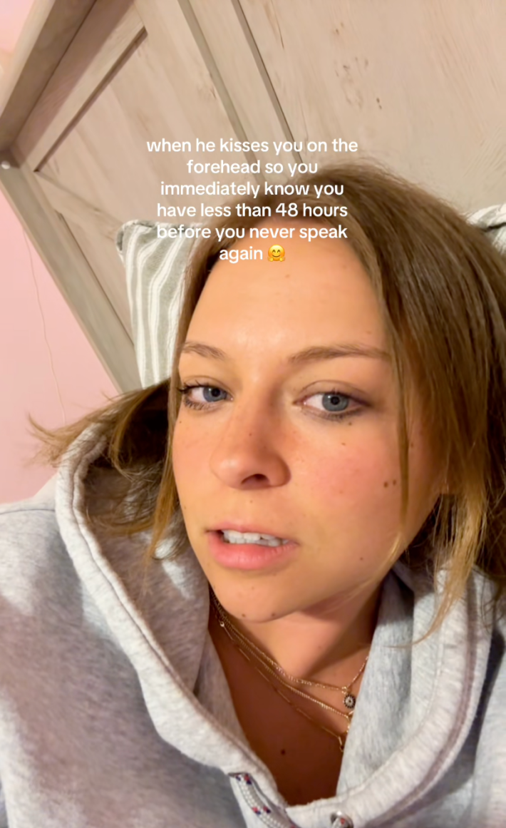 Woman staring at her camera, unamused. Text overlay reads, "when he kisses you on the forehead so you immediately know you have less than 48 hours before you never speak again."