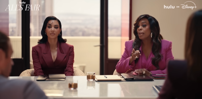 Kim Kardashian and Nicey Nash at a board room table.