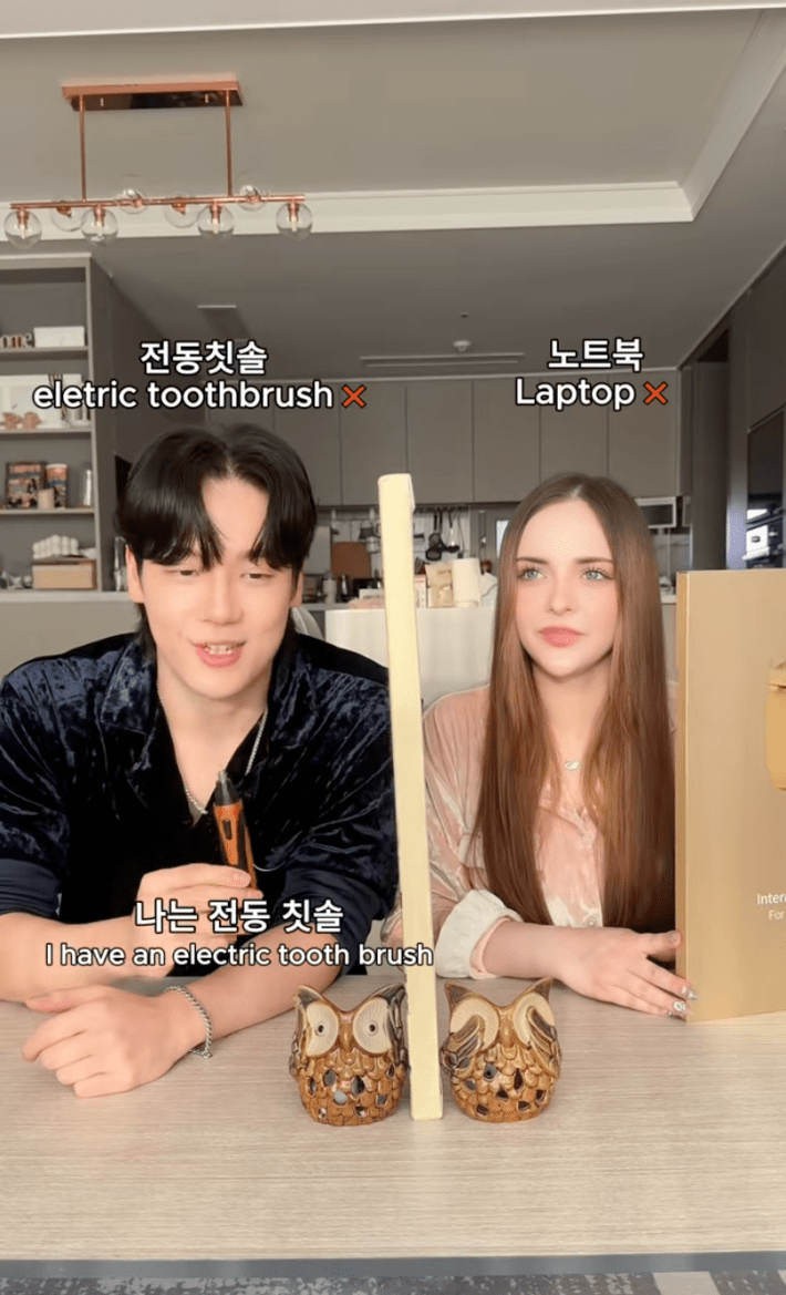 A man and woman playing the lying challenge in their kitchen.