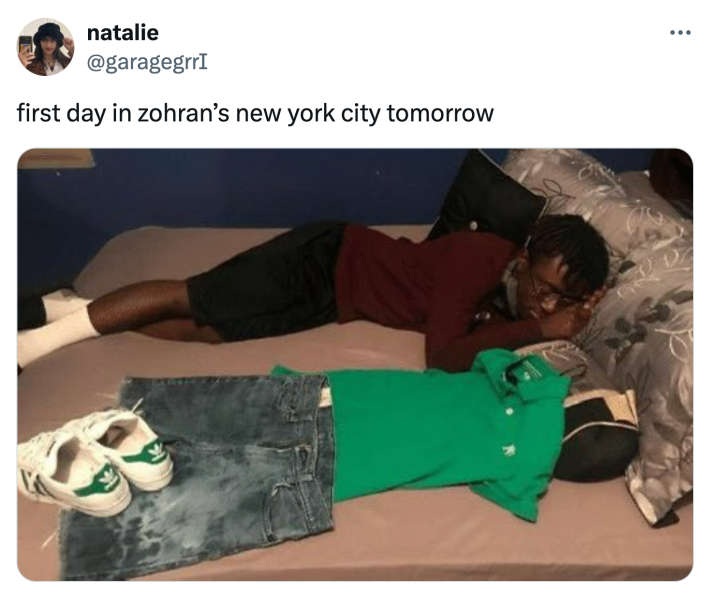 Tweet that reads, "first day in zohran’s new york city tomorrow" with a person on the bed next to their outfit for the next day.