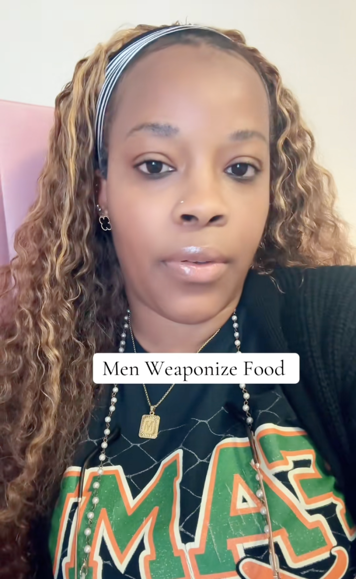 A woman deadpan staring at the camera. Text overlay reads, "Men Weaponize Food."