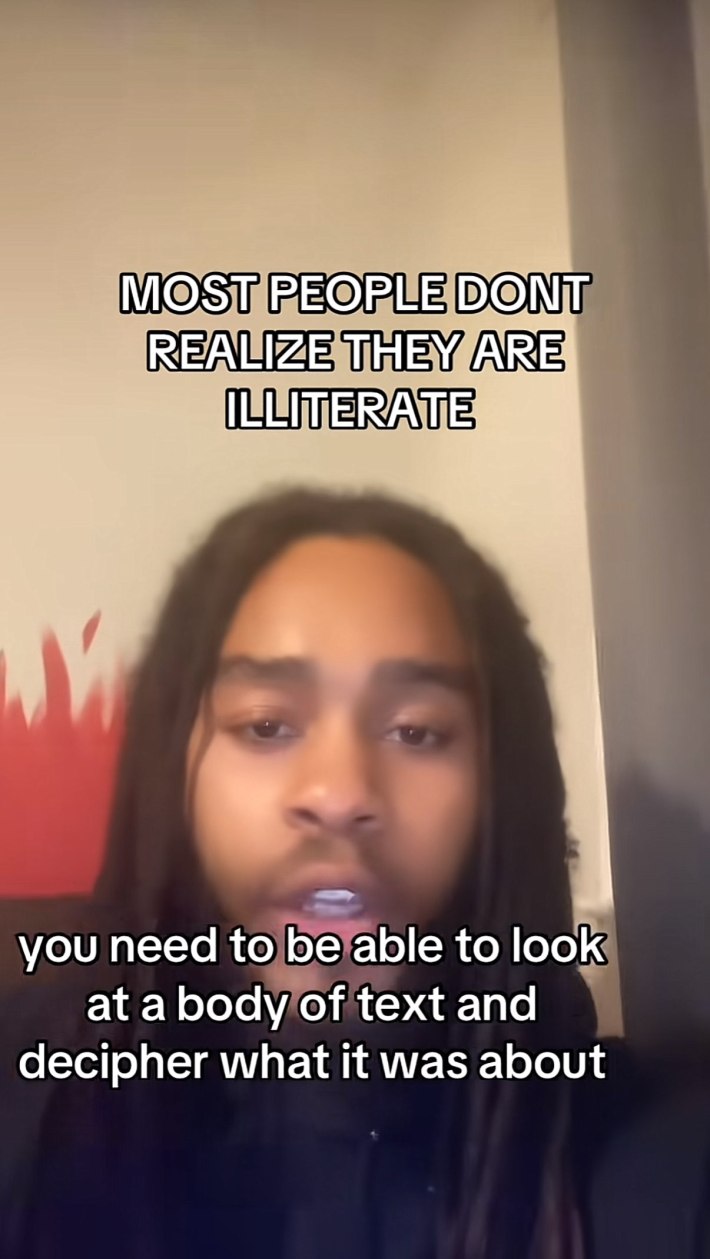 A man with dreads talking to the camera. Text overlay reads, "Most people don't realize they are illiterate." and captions read, "you need to be able to look at a body of text and decipher what it was about."
