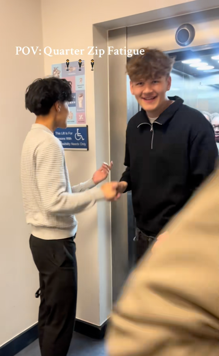 A group of boys getting off the elevator.