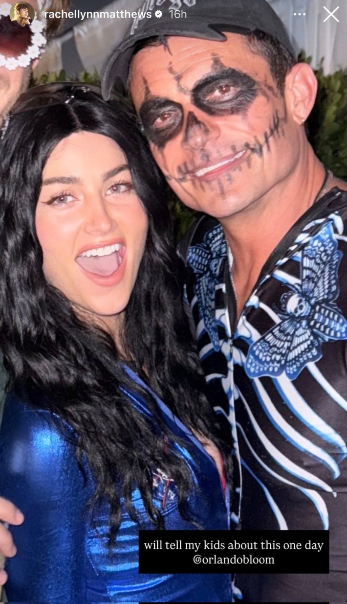 Rachel Lynn Matthews dressed as Katy Perry for Halloween, posing next to Orlando Bloom for a photo.