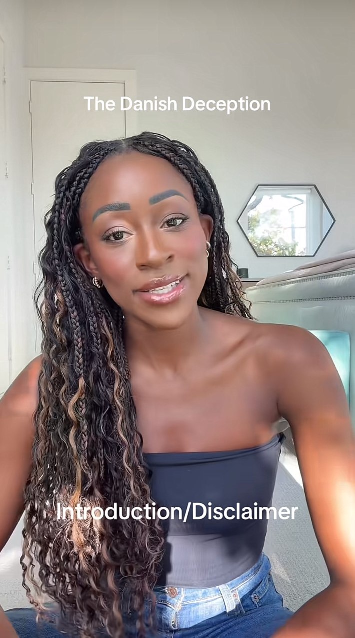 A Black woman sitting down in a sunny room to talk to her camera. She looks earnest as she speaks. Text overlay reads, "Introduction/Disclaimer"
