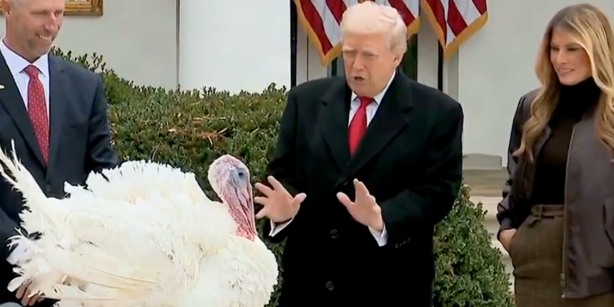 President Donald Trump speaking to a turkey during the annual White House turkey pardon, First Lady Melania Trump by his side