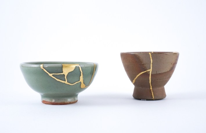 two ceramic pots with gold holding pieces together