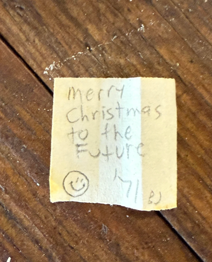 u/ashleygee via Reddit One of the rolled up pieces of paper dated 1971 read, “Merry Christmas to the future!"