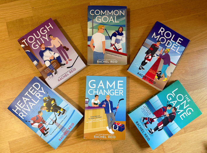 The six Game Changers series books spread out on a hardwood floor.