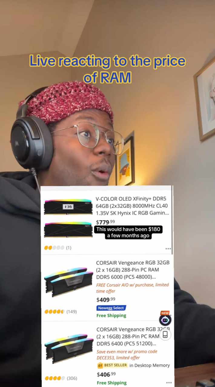 A man looking shocked as he sees the price of RAM, green screened over his video. Text overlay reads, "Live reacting to the price of RAM," and a listing priced at $779 that he notes would have been $180 a few months ago.