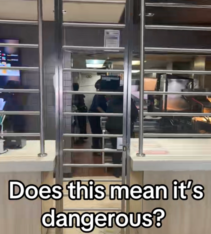 @travel2wealthh/TikTok McDonalds with security bars and onscreen text that reads, "Does this mean it's dangerous?"