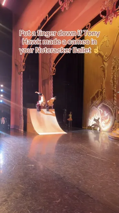 Tony Hawk and Katelyn West skateboarding on stage in Russian dancer costumes for a production of The Nutcracker.