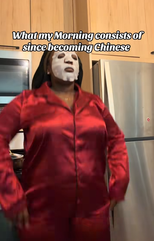 Video of a woman in pajamas and a face mask with a caption reading "What my Morning consists of since becoming Chinese."