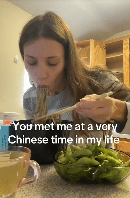 TikTok video of a woman eating noodles with a caption reading "You’ve met me at a very Chinese time in my life."