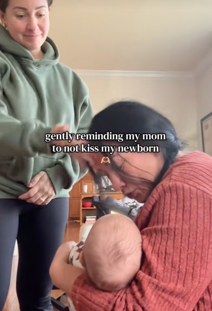 onscreen text, “gently reminding my mom not to kiss my newborn.” grandma kissing baby and getting slapped