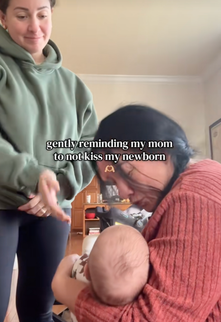 onscreen text, “gently reminding my mom not to kiss my newborn.” grandma kissing baby and getting slapped